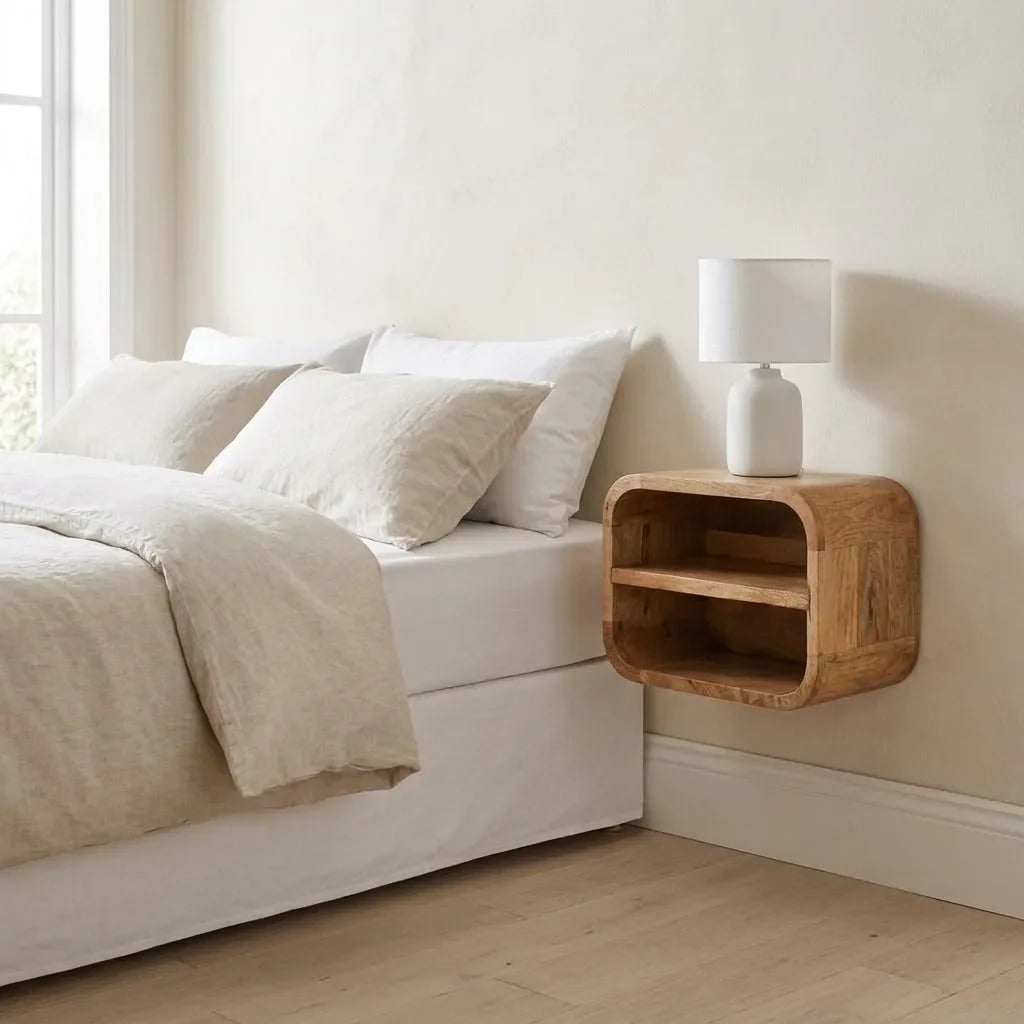 A 35 cm wall-mounted bedside table with two open shelves, fixed beside a bed