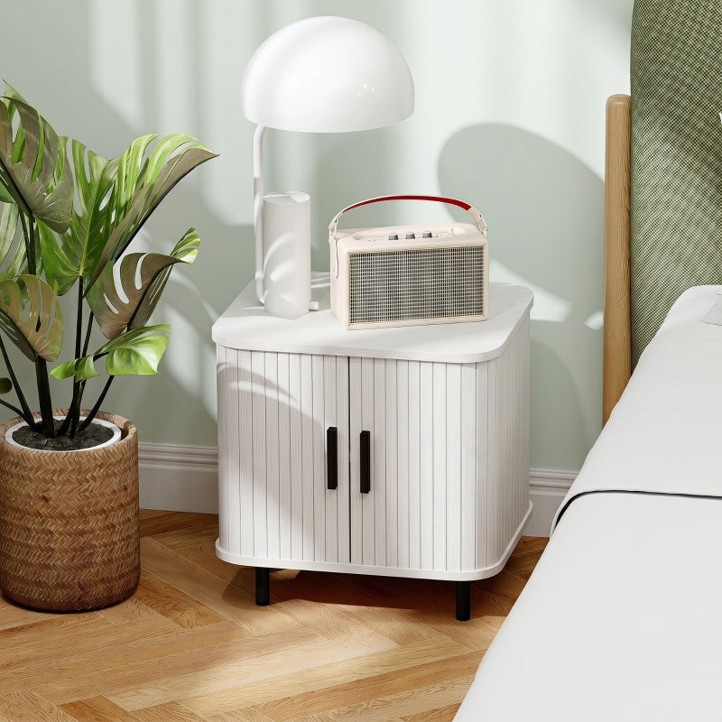 White ribbed-door bedside cabinet beside a bed