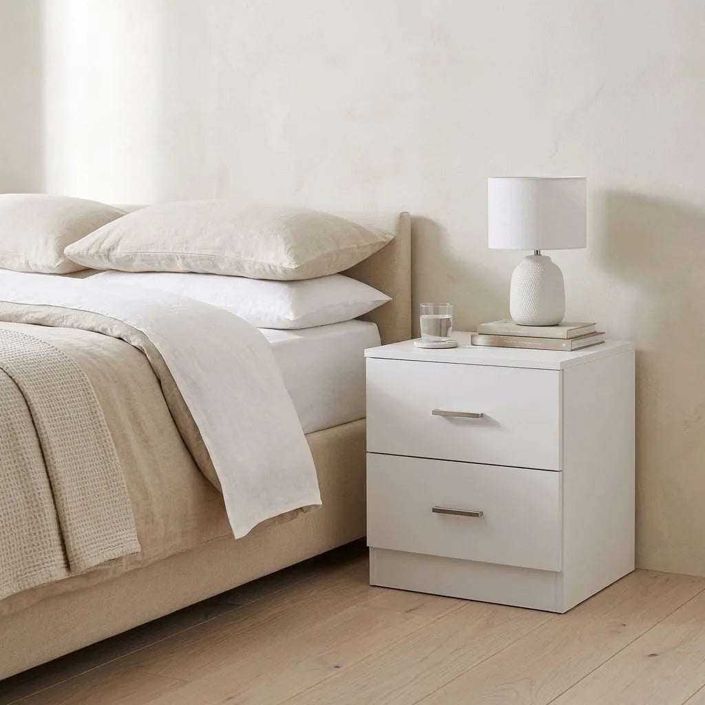 2 Drawer Bedside Table beside a bed with linen bedding, with a table lamp on top
