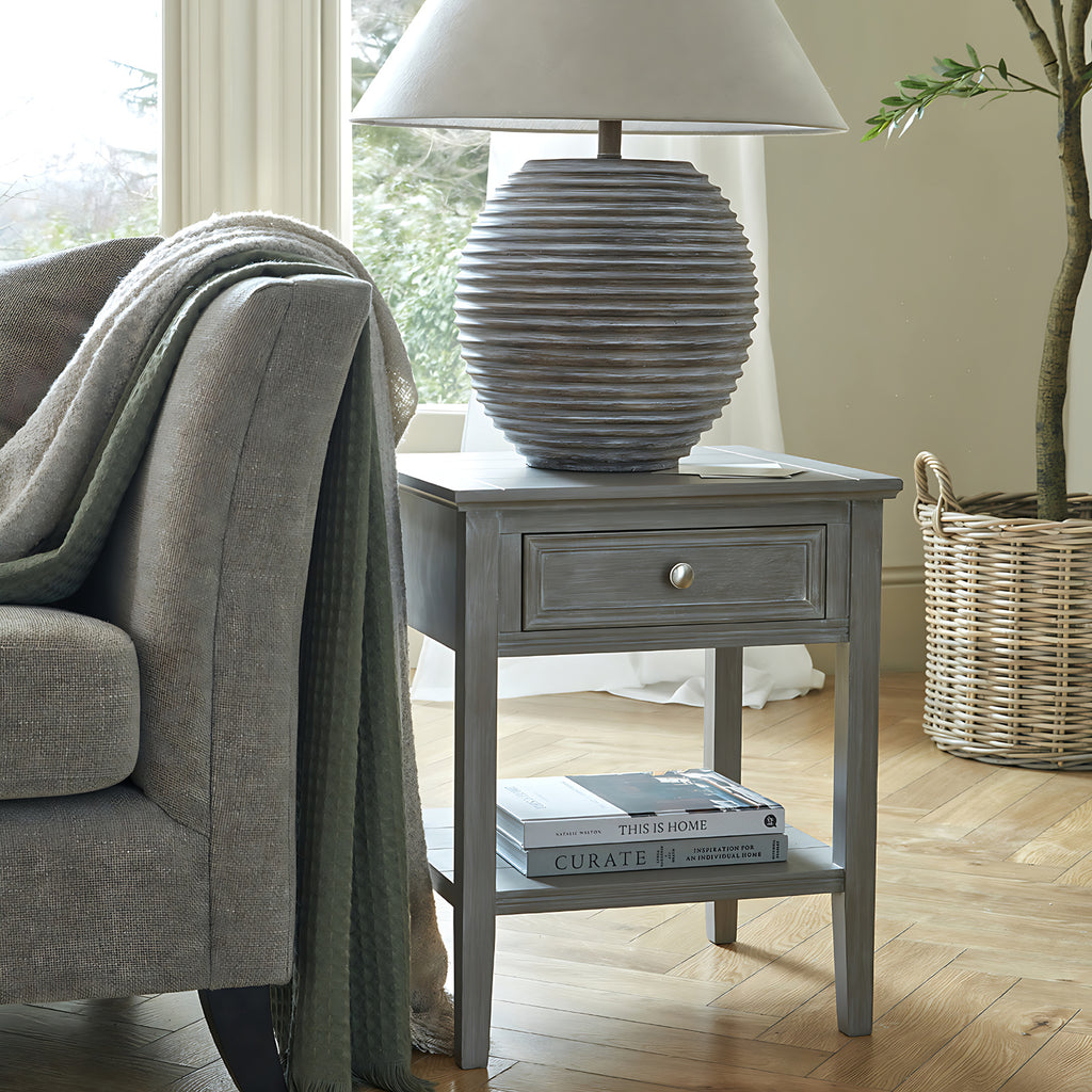 Serene side table styled next to an armchair