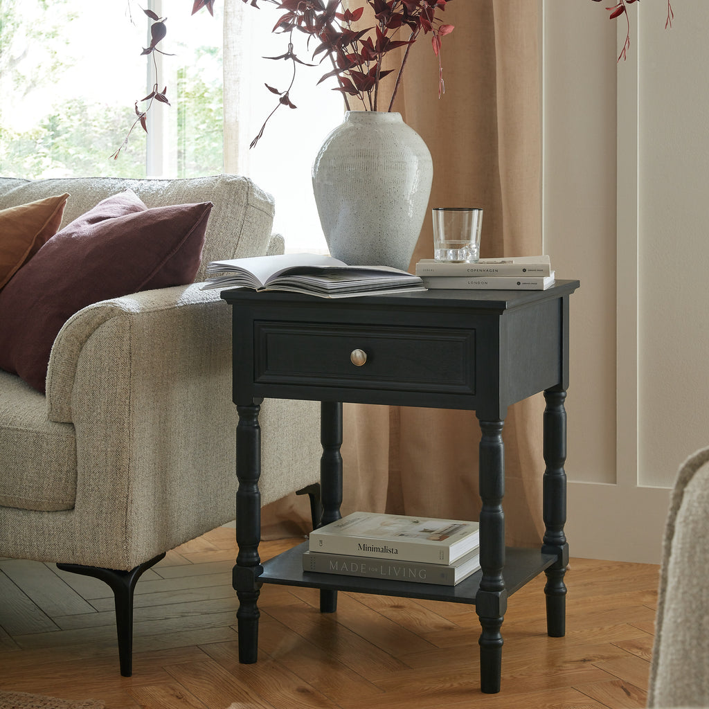 Fowey side table styled next to a sofa