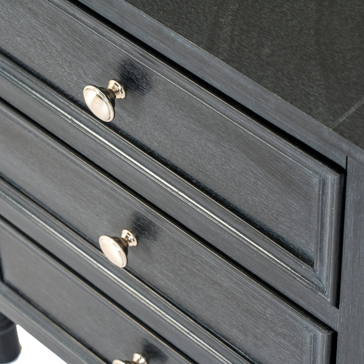 Close-up of the panelled drawers and round knobs on the Fowey three drawer table