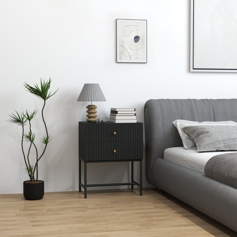Black bedside table with metal frame beside a bed