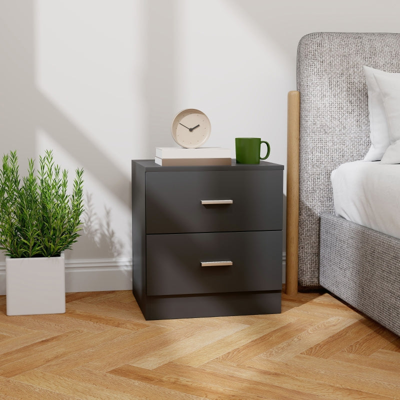 Black two-drawer bedside table beside a bed