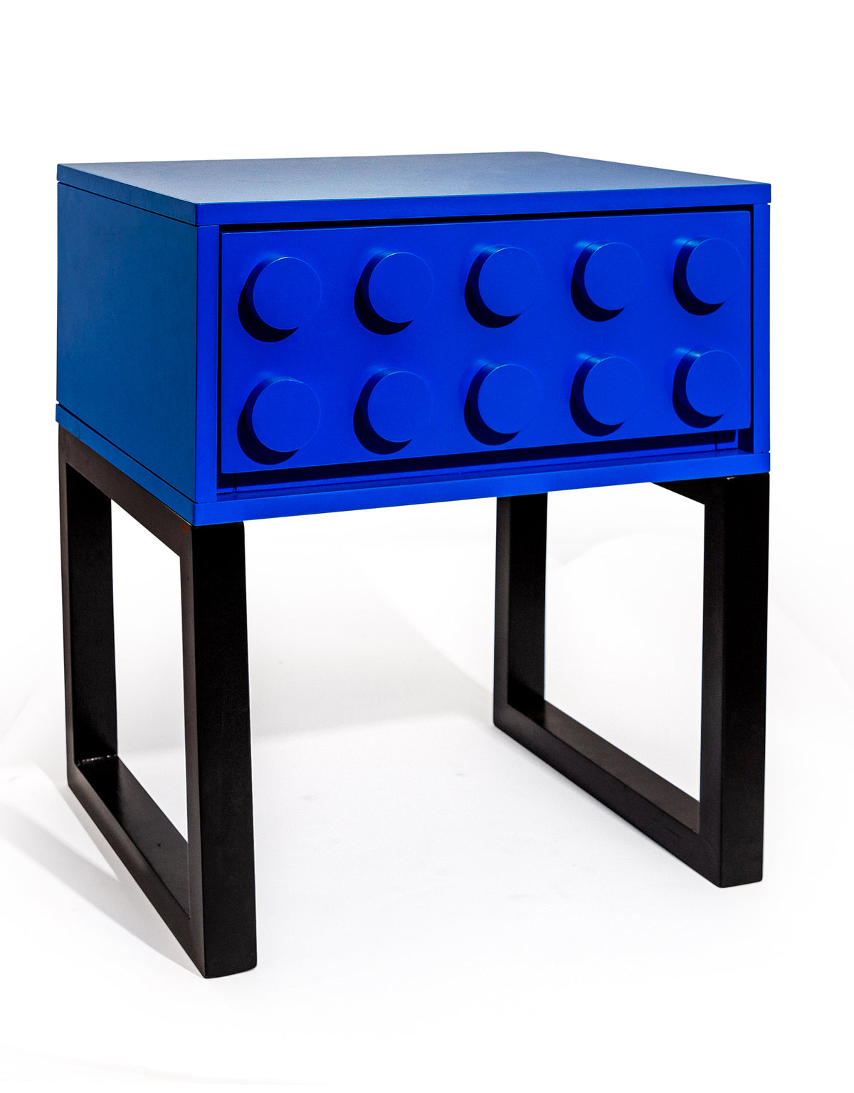 Colour block bedside table in blue, 46.5 cm wide, one studded drawer on a black open frame