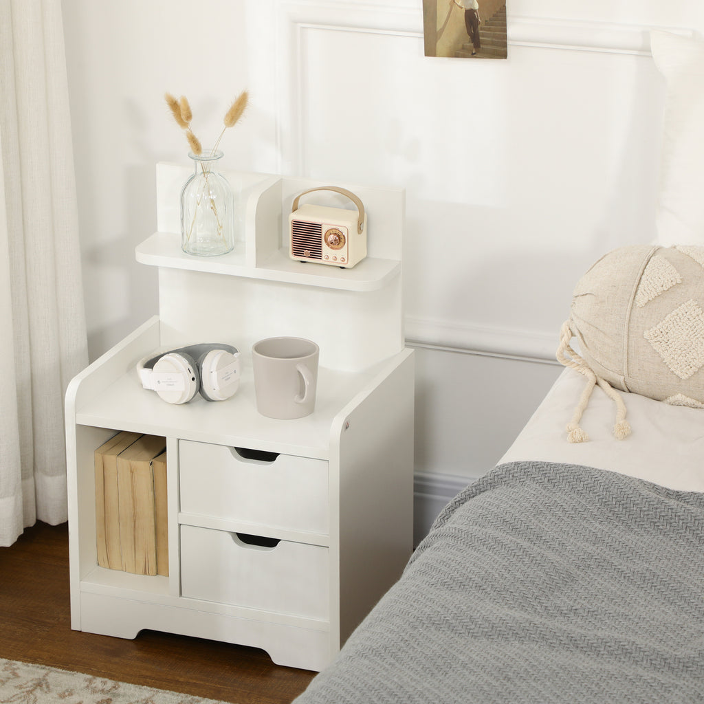 White bedside table with top shelf beside a bed