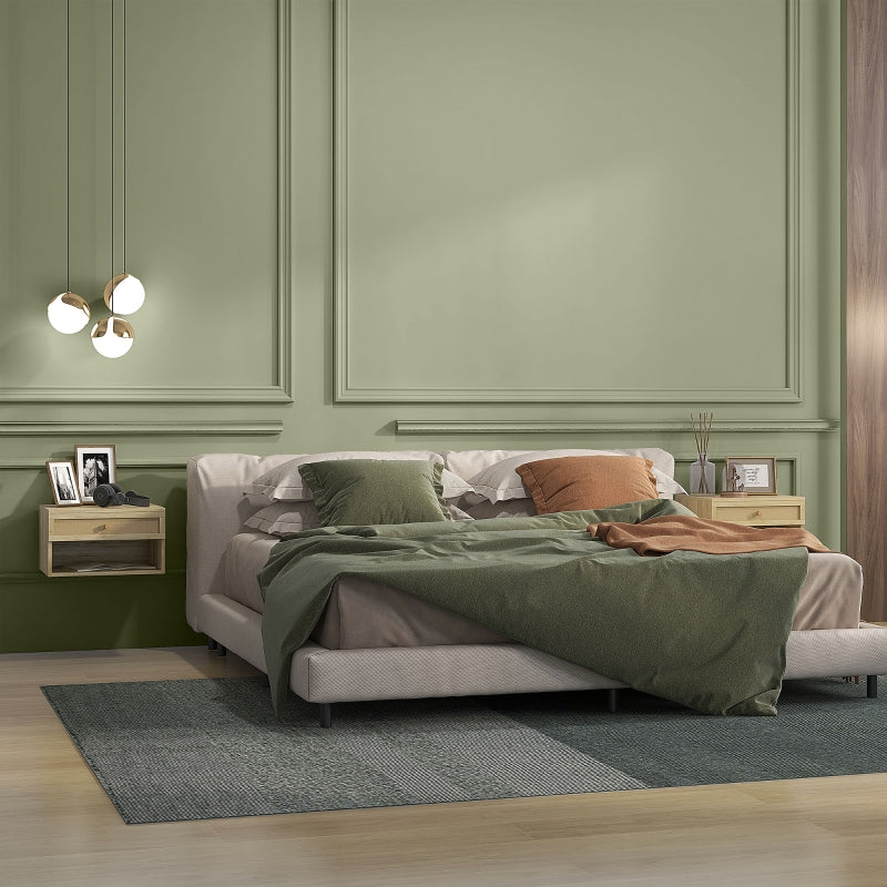 Floating rattan bedside table beside a bed in a green bedroom
