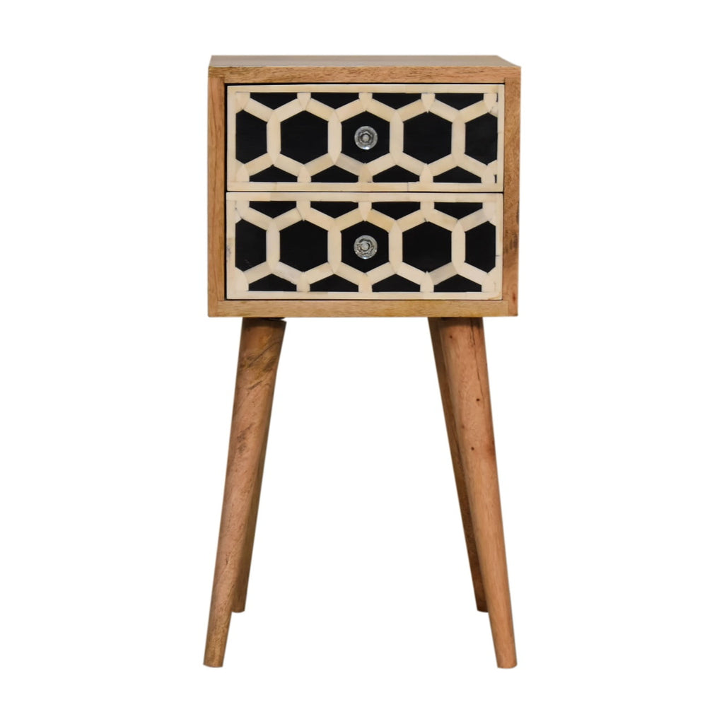 Small oak-tone bedside table with two black and cream honeycomb-pattern drawers on four tapered legs, front view