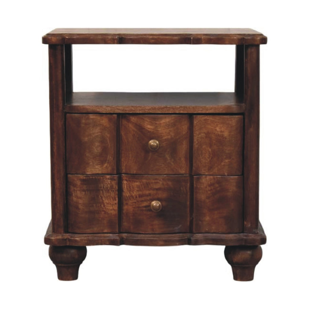 Wide bedside table with an open shelf above two wavy panelled drawers with brass knobs, on turned feet, front view
