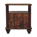 Wide bedside table with an open shelf above two wavy panelled drawers with brass knobs, on turned feet, front view