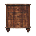 Three-drawer bedside table with wavy panelled drawer fronts, brass knobs and turned feet, front view