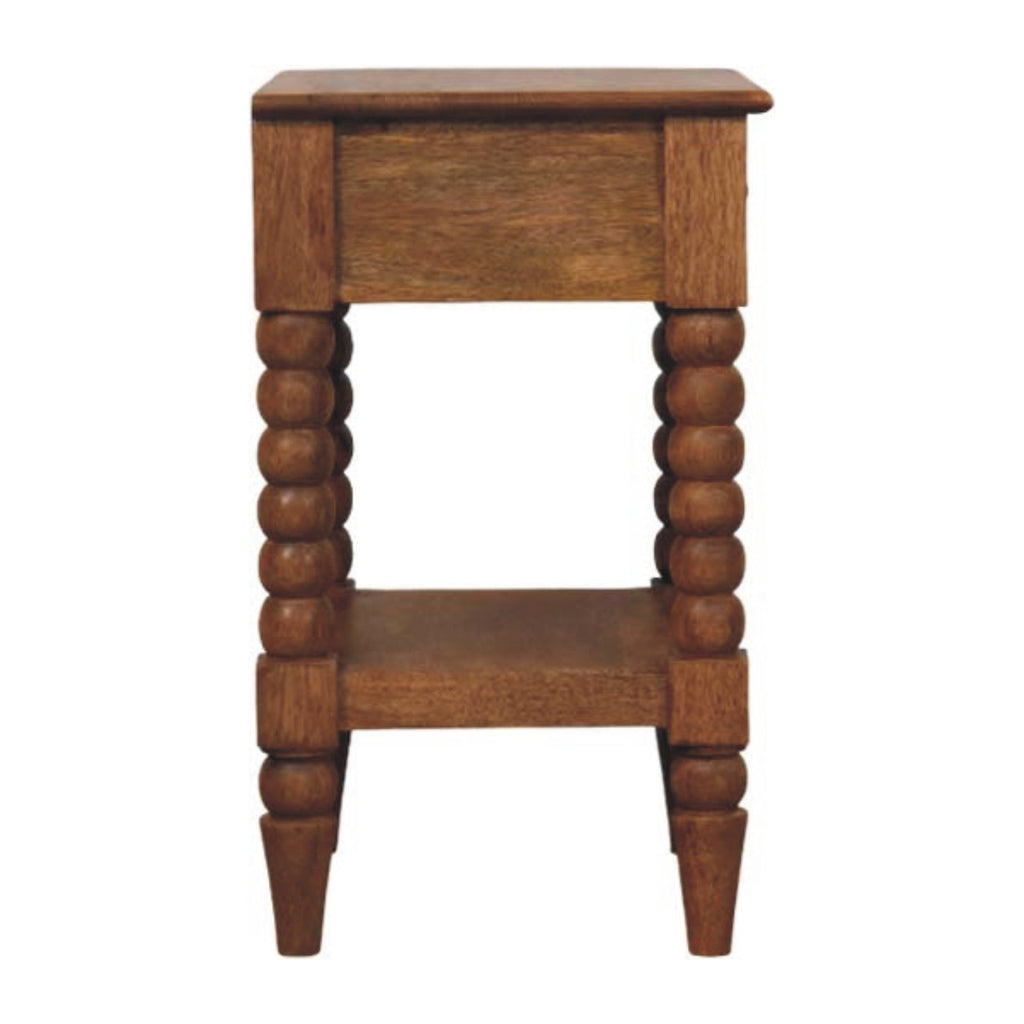 Side view of the Spindle bedside showing turned legs and lower shelf