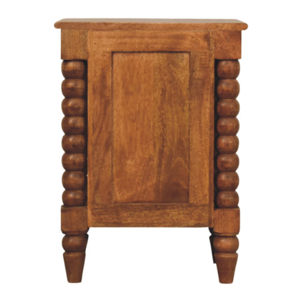 Back view of the amber-brown bedside table with a framed back panel and turned feet