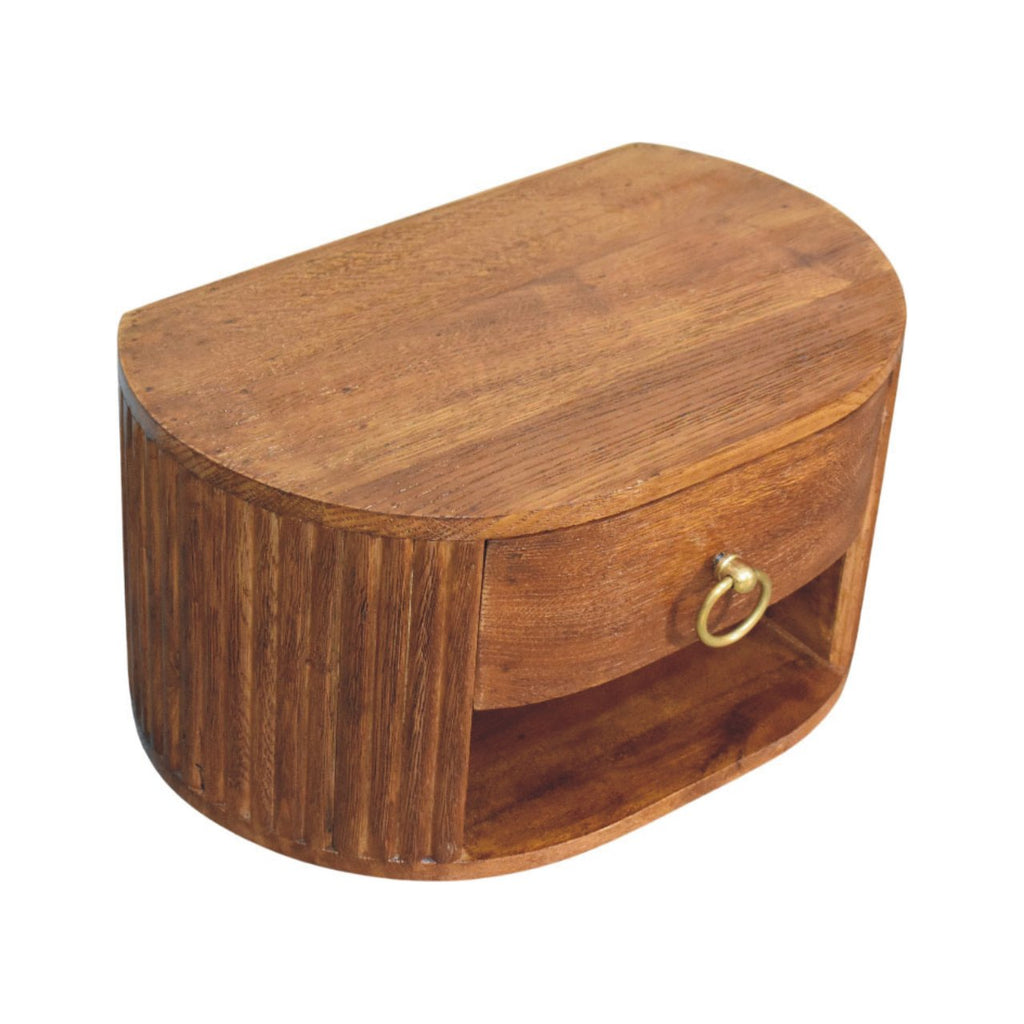 Oval wall nightstand seen from above showing the rounded oak top and brass ring pull