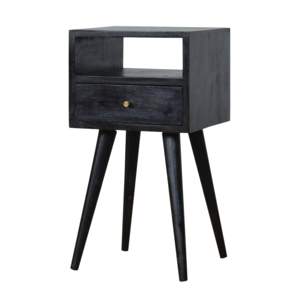 Small black ash-finish bedside table with an open cubby above one drawer, on four tapered black legs, front view
