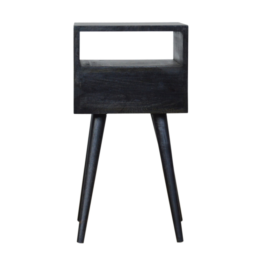 Back view of the small black bedside table with the open cubby above a plain back panel