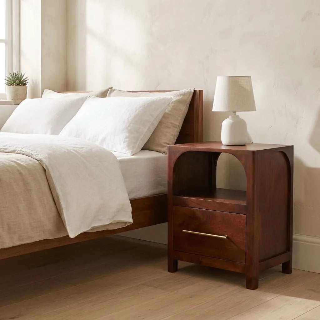 Arched Shelf Bedside Table beside a bed with linen bedding, with a table lamp on top