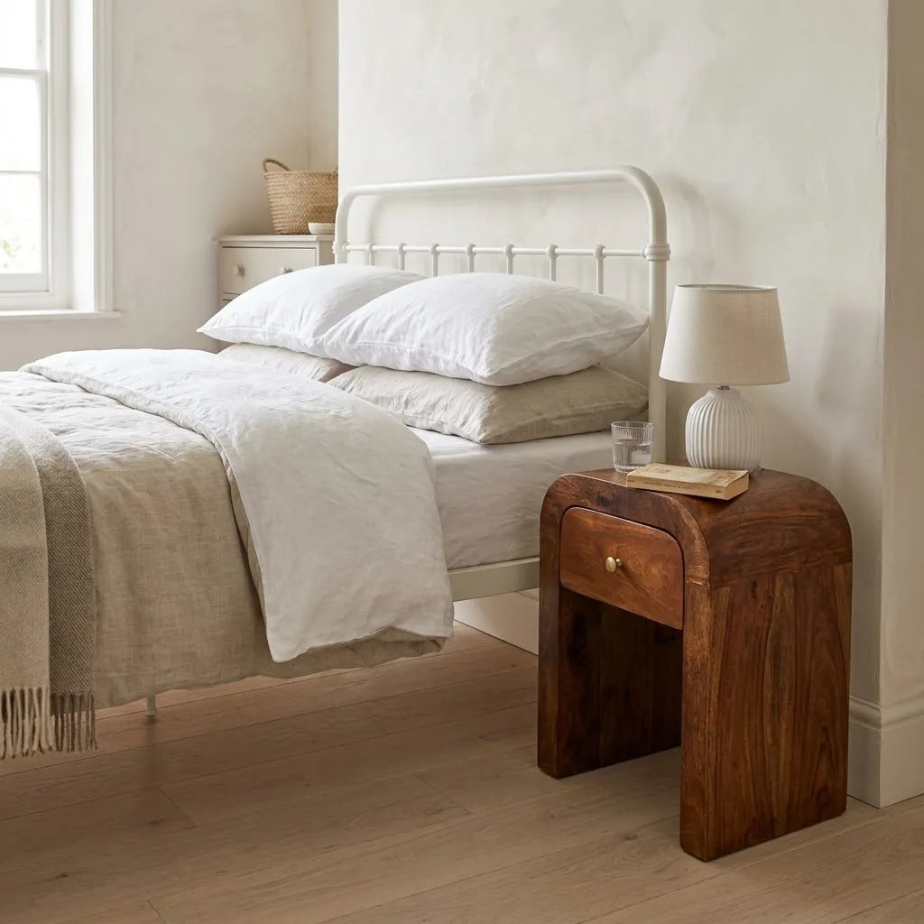 Arun 30 cm Bedside Table beside a bed with linen bedding, with a table lamp on top