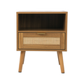 Walnut bedside table with rattan drawer front, open shelf and angled legs on a white background