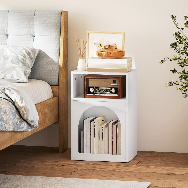 White arched bedside table beside a bed