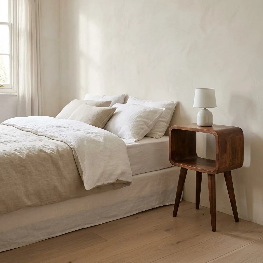 Eden 30 cm Open Bedside Table beside a bed with linen bedding, with a table lamp on top