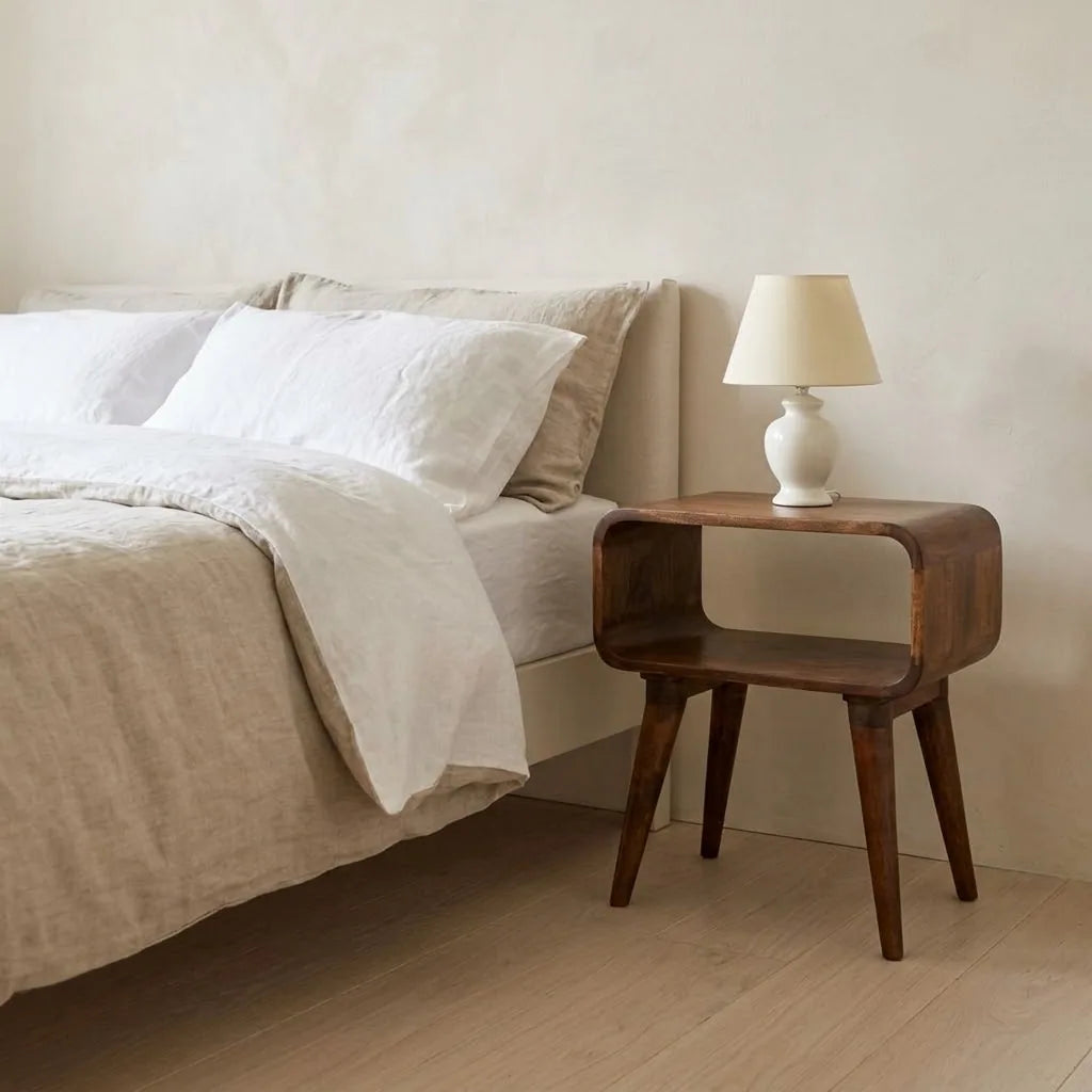 Eden 45 cm Open Bedside Table beside a bed with linen bedding, with a table lamp on top