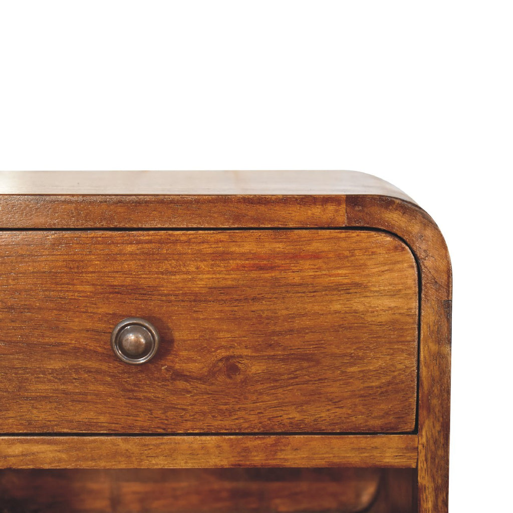 Close-up of the drawer knob and wood grain on a chestnut brown floating bedside table, 30 cm
