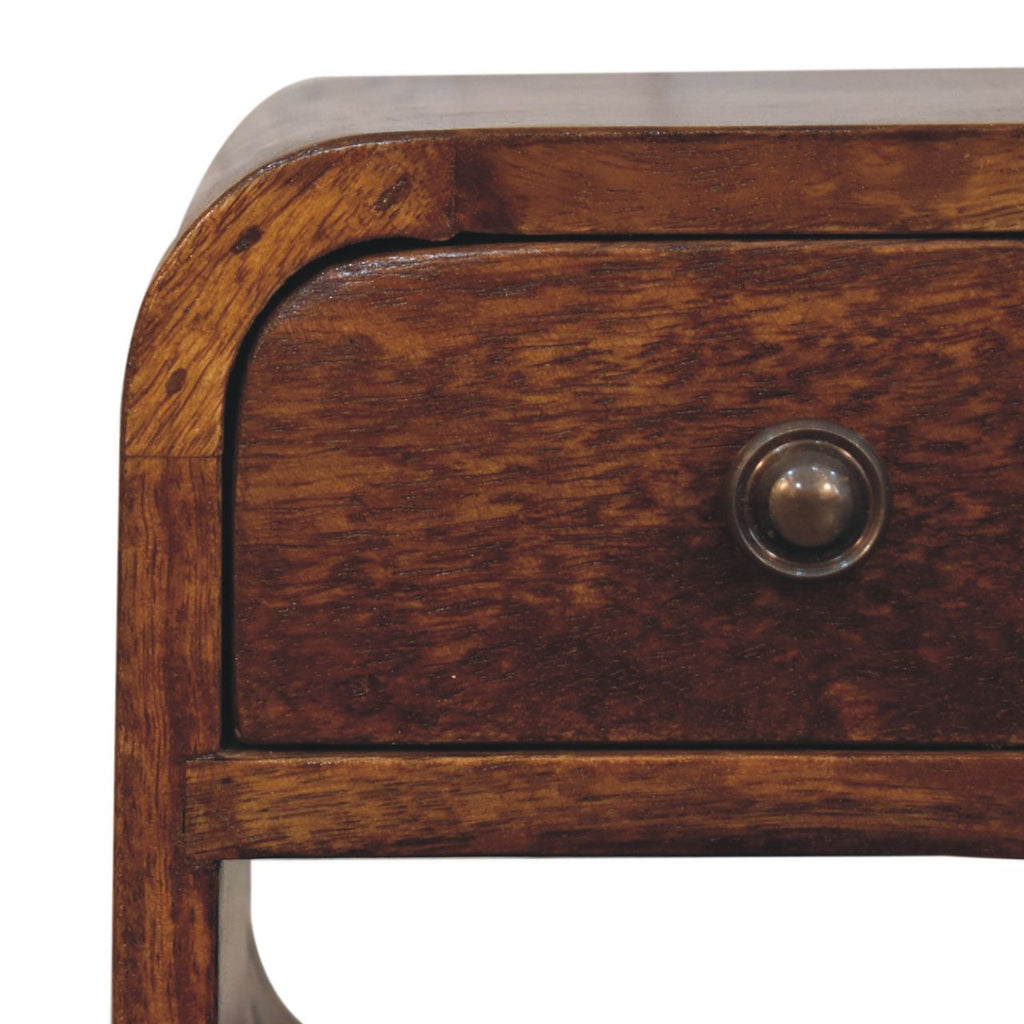 Narrow bedside table in chestnut brown, close-up of the wood grain and round drawer knob