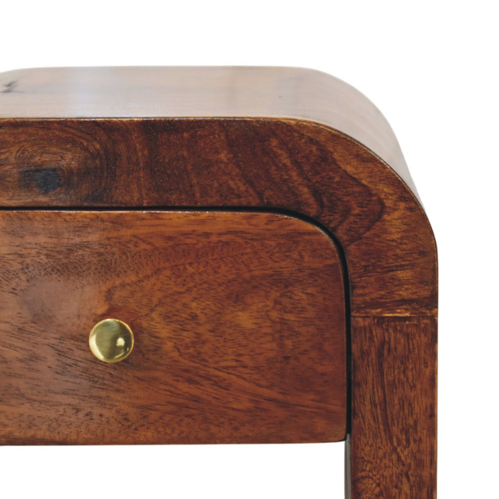 Narrow arch-shaped bedside table, 30 cm wide, chestnut brown, close-up of the wood grain and brass knob