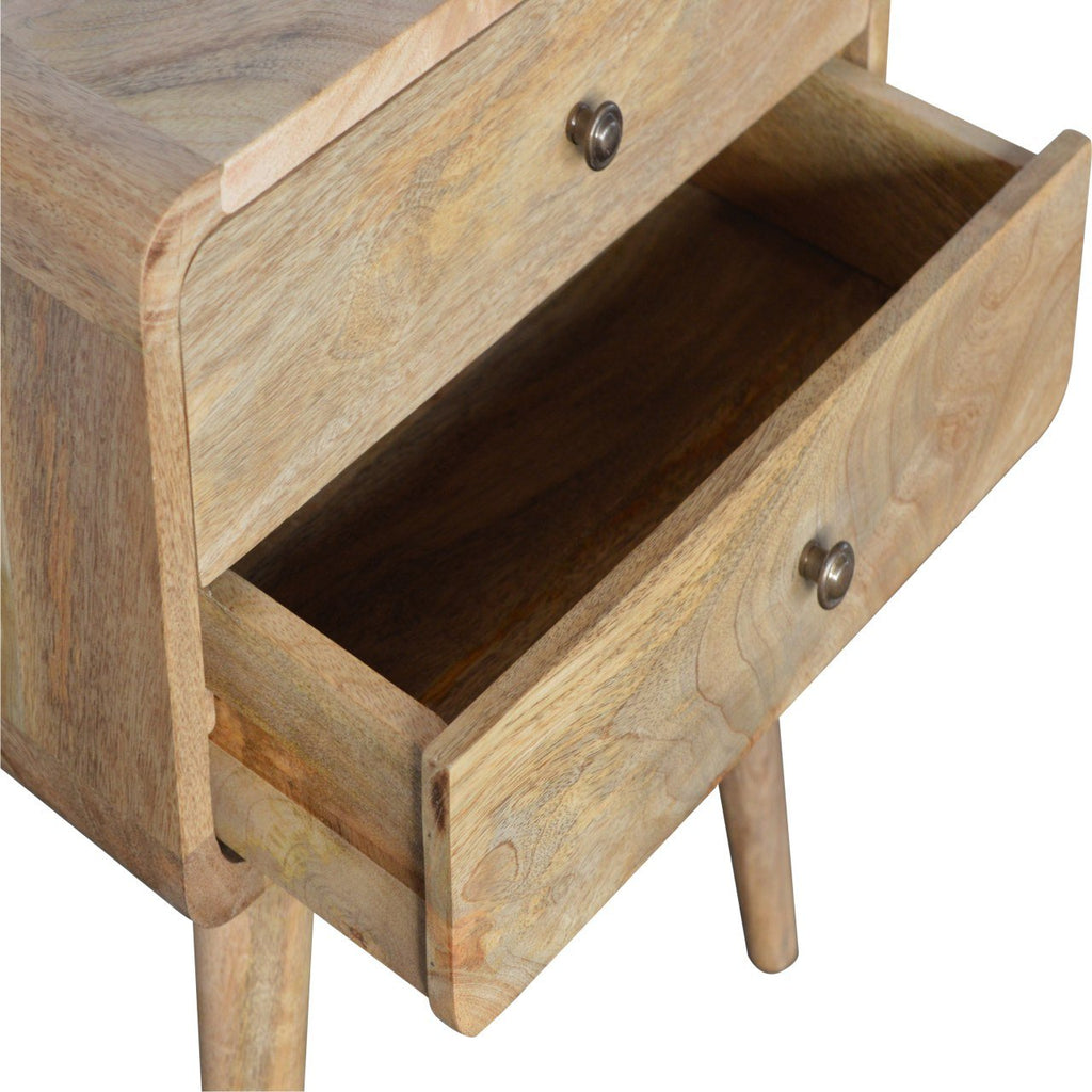 Curved oak-ish bedside with the top drawer open