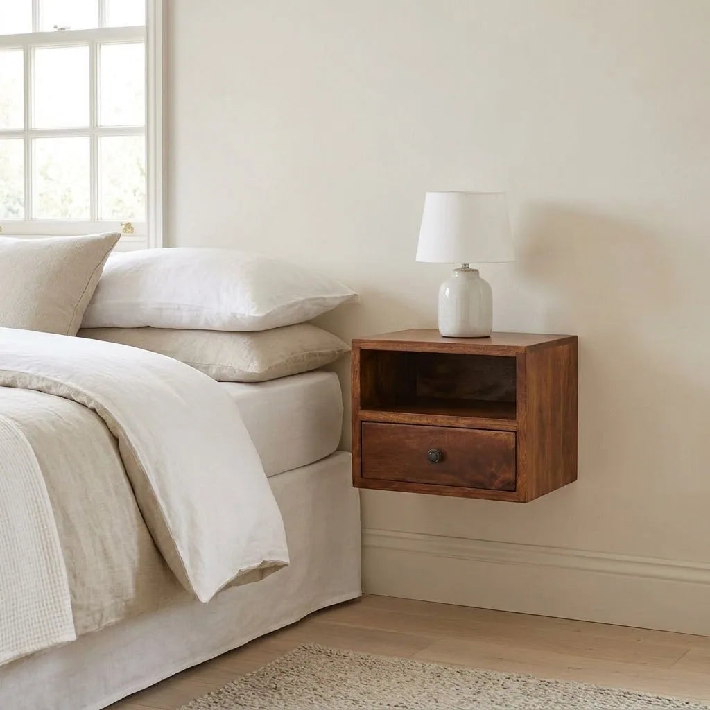 Severn 30 cm Wall Mounted Bedside Table fixed to the wall beside a bed, with a table lamp on top