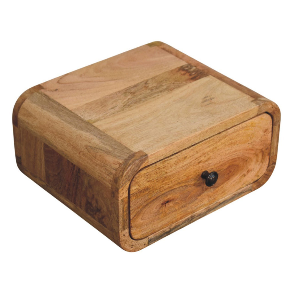 Top of the light wall mounted bedside table showing the mango grain