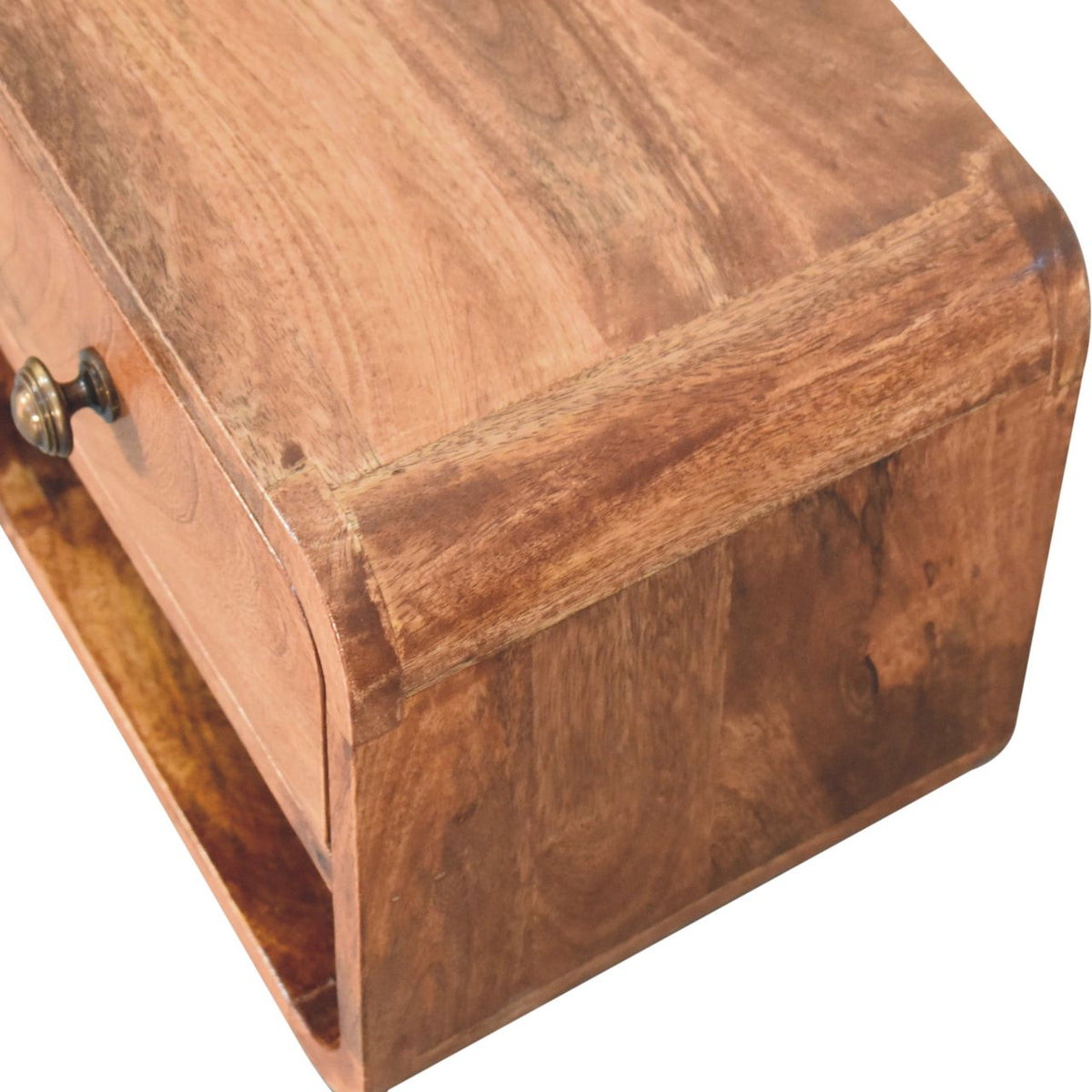 Top corner close-up of a honey caramel wall-mounted bedside table, 30 cm wide, showing wood grain
