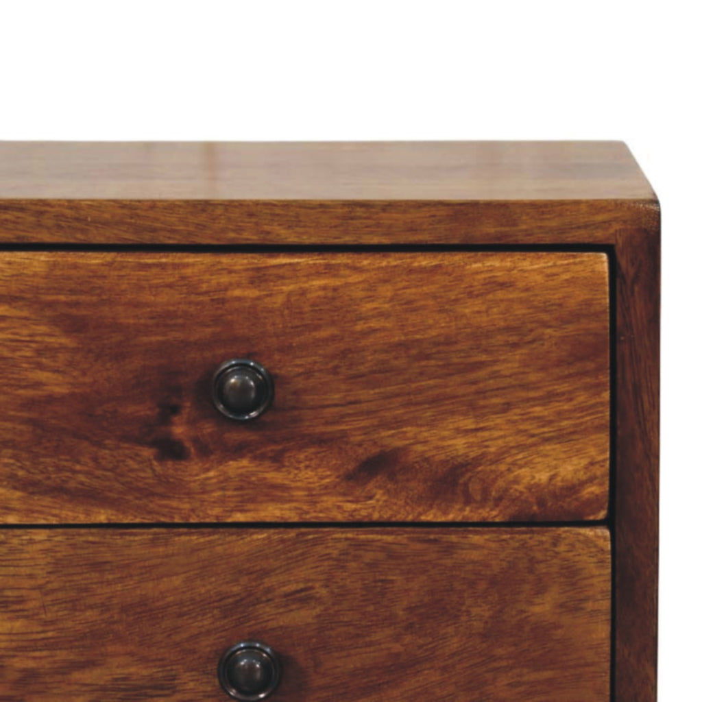 Close-up of the top corner and drawer knobs on a chestnut brown 2-drawer bedside table
