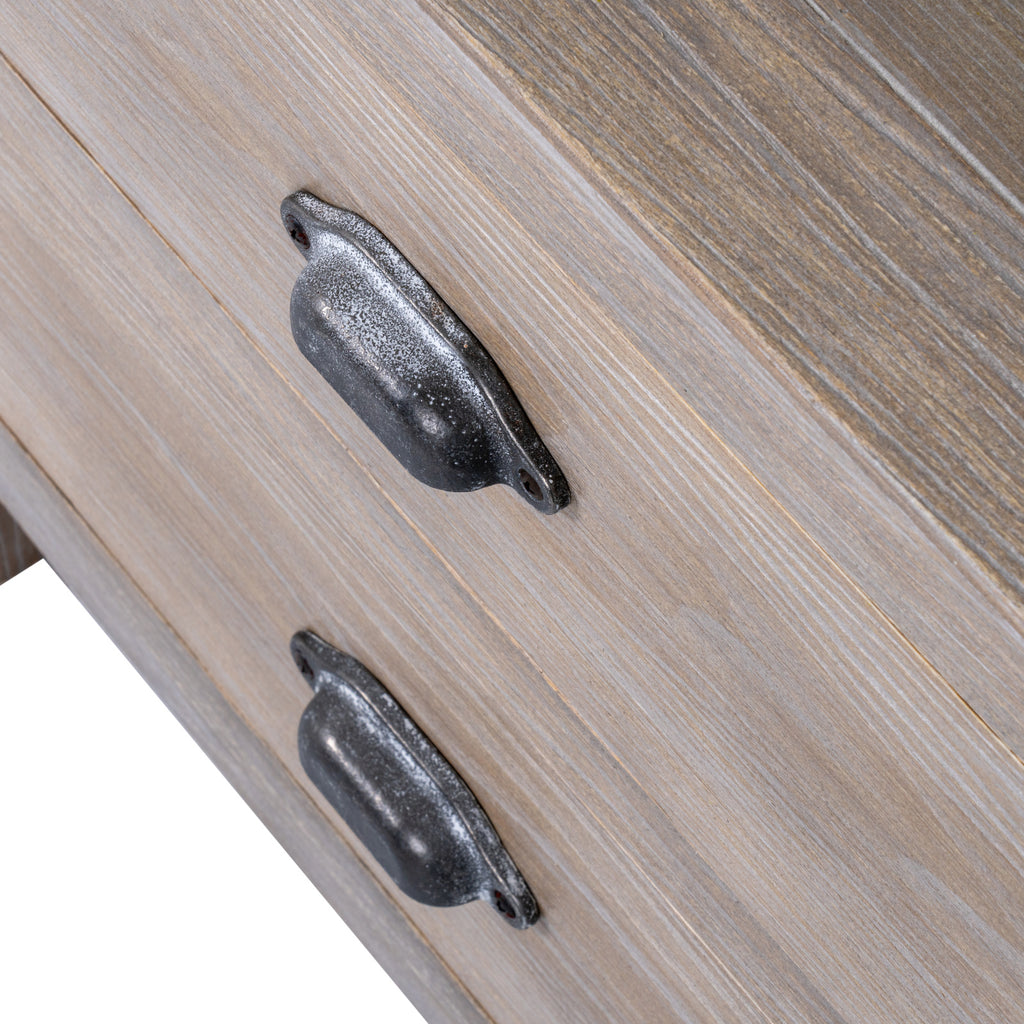 Close-up of the dark metal cup handles on the washed wood drawers
