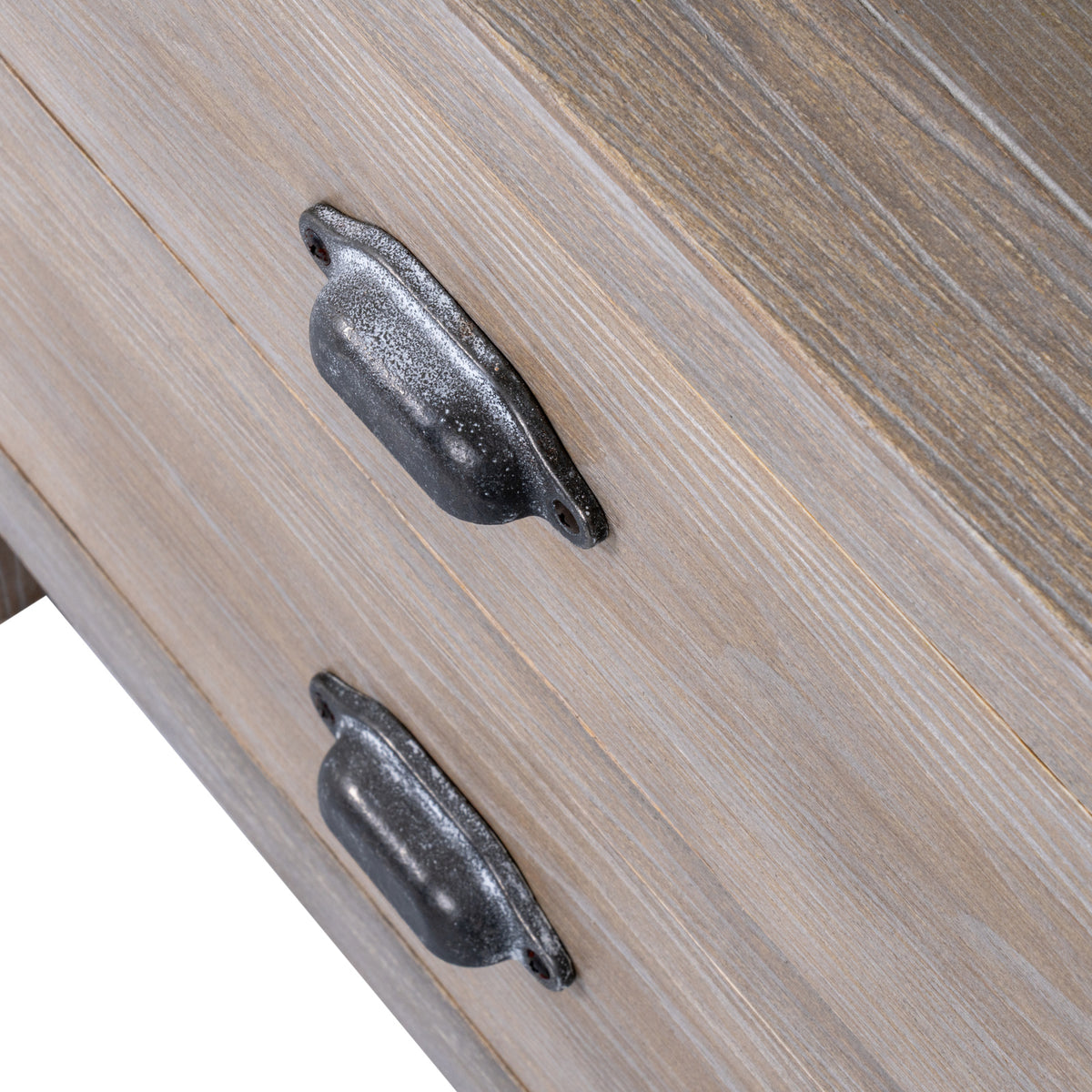 Close-up of the dark metal cup handles on the washed wood drawers